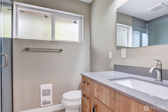 full bath with visible vents, baseboards, toilet, vanity, and a shower stall