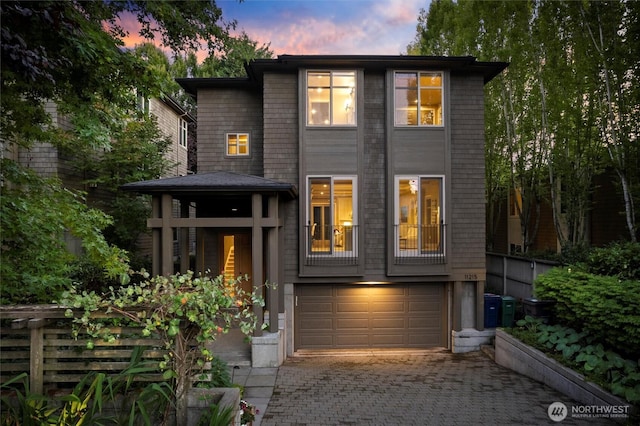 view of front facade with a garage and decorative driveway