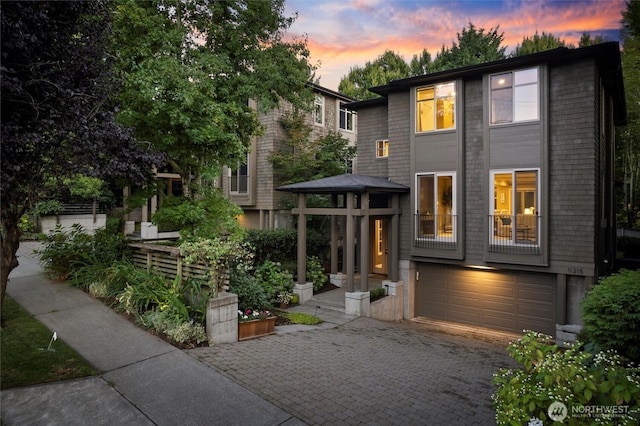 view of front of property with decorative driveway and an attached garage