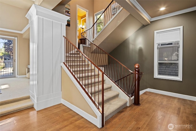 stairs with crown molding, wood finished floors, baseboards, and recessed lighting