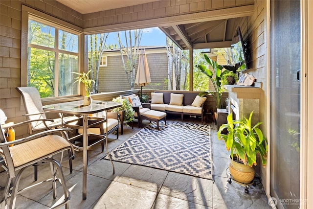 sunroom / solarium with outdoor lounge area and a healthy amount of sunlight