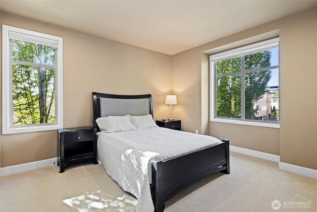 bedroom with multiple windows, baseboards, and carpet floors
