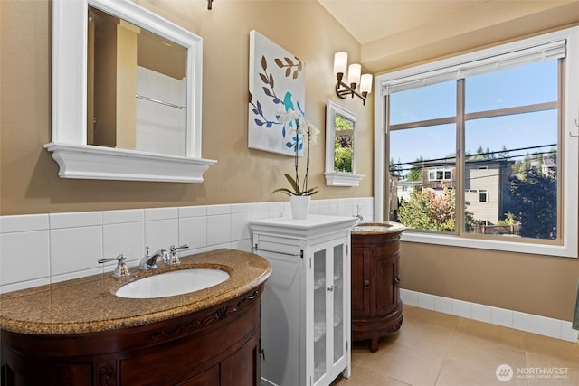 bathroom featuring a sink, two vanities, and tile patterned flooring