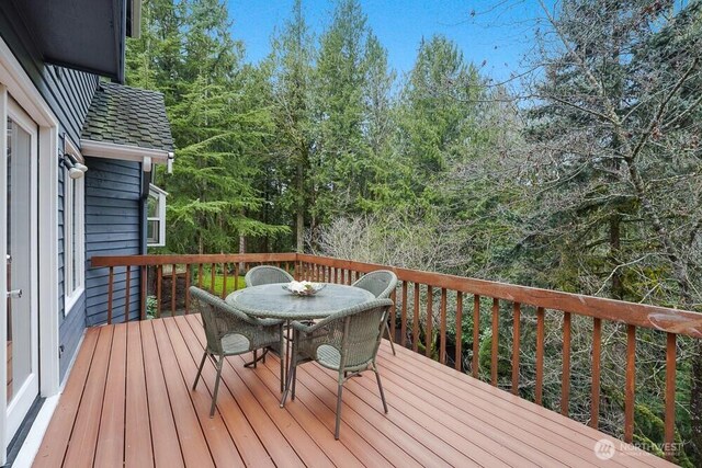 wooden deck featuring outdoor dining space