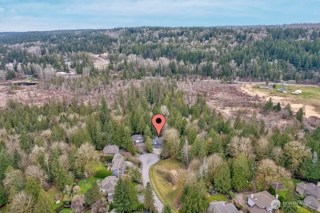 drone / aerial view featuring a forest view