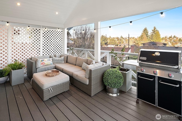 wooden deck featuring a grill and an outdoor living space