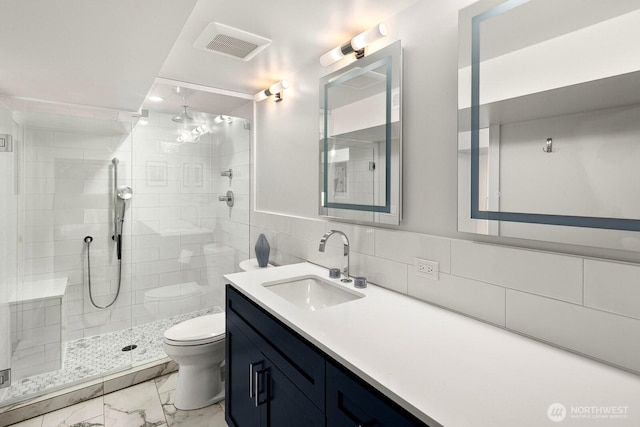 full bath featuring a stall shower, visible vents, toilet, marble finish floor, and vanity