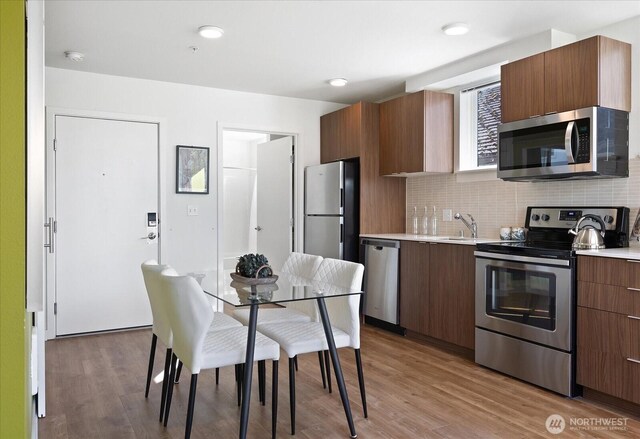 kitchen featuring light countertops, modern cabinets, and stainless steel appliances