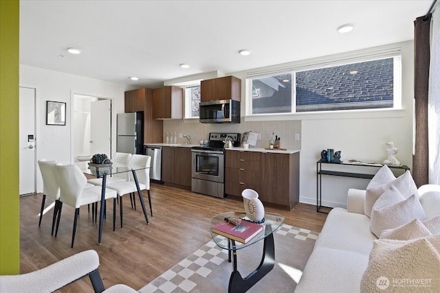 living area featuring recessed lighting and light wood-style flooring