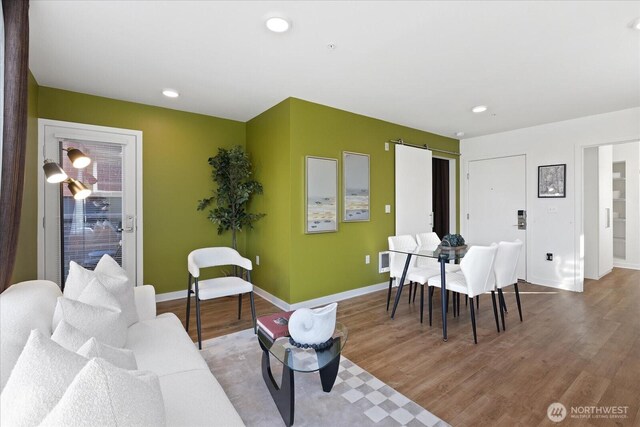 living room with baseboards and wood finished floors