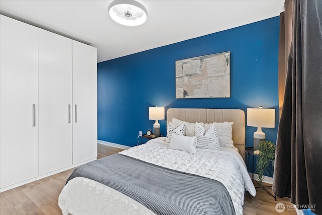 bedroom with wood finished floors and baseboards