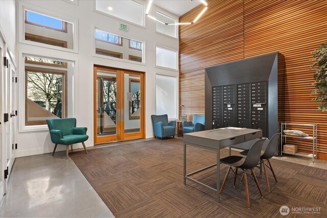 office featuring a high ceiling, french doors, and baseboards