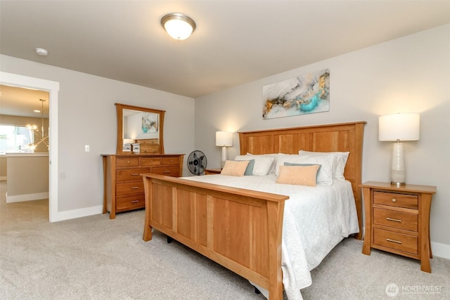 bedroom with baseboards and light carpet