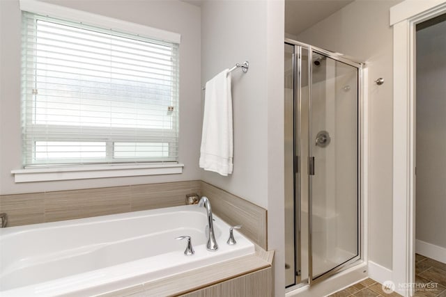 bathroom with a bath, tile patterned flooring, and a stall shower