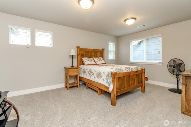 bedroom featuring visible vents, baseboards, and light colored carpet