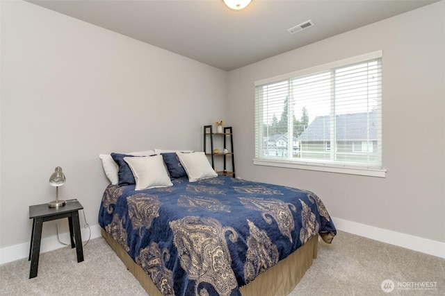 carpeted bedroom featuring visible vents and baseboards