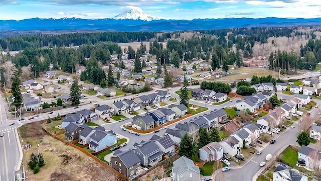 bird's eye view with a residential view, a mountain view, and a wooded view