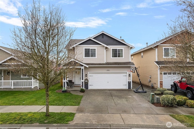 view of front of house featuring a front yard, covered porch, concrete driveway, and an attached garage