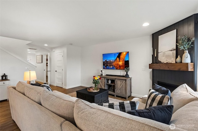 living area featuring stairway, recessed lighting, wood finished floors, and baseboards