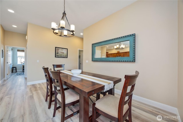 dining space with light wood-style floors, recessed lighting, baseboards, and an inviting chandelier