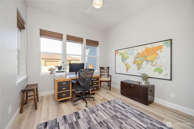 office featuring a ceiling fan, light wood-style flooring, and baseboards