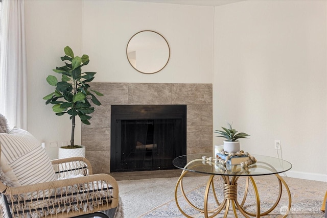 living room with a fireplace and baseboards