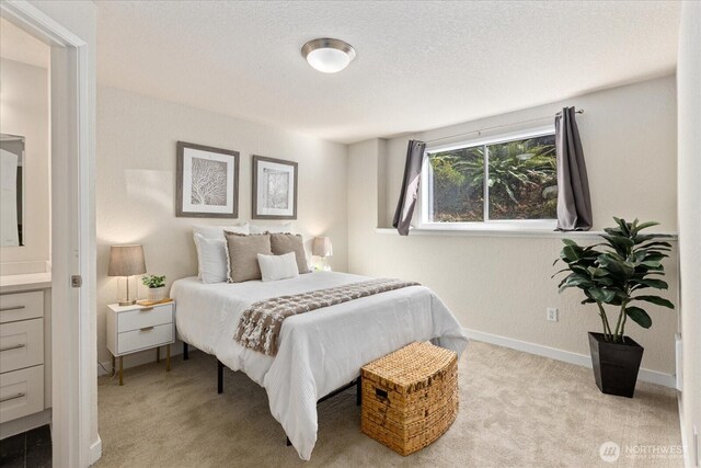 bedroom featuring a textured ceiling, carpet flooring, and baseboards