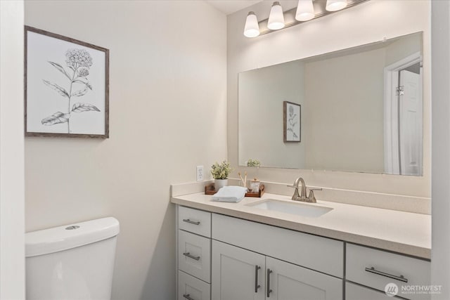 half bathroom with toilet and vanity