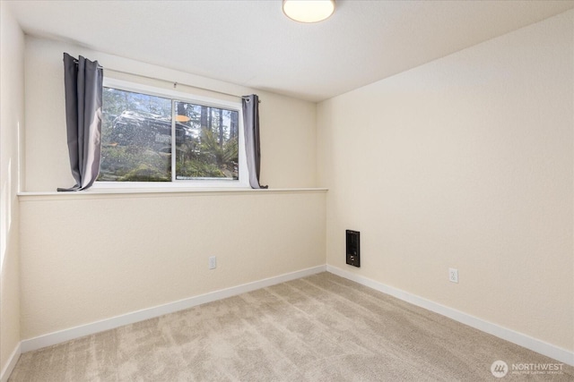 carpeted spare room with baseboards