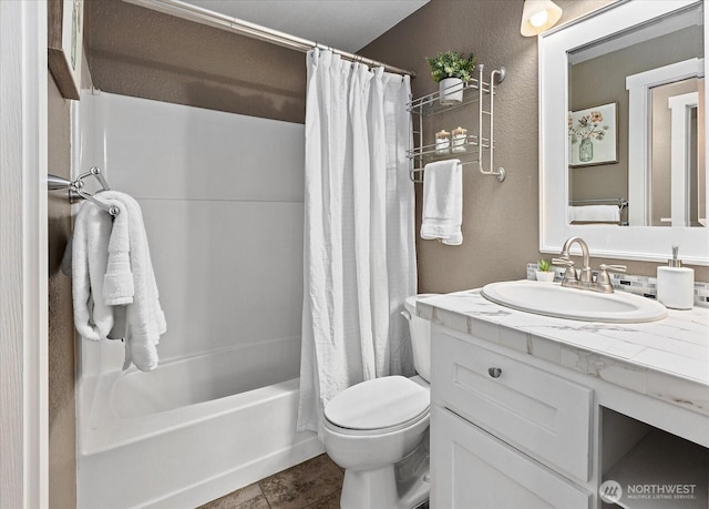 full bathroom featuring a textured wall, shower / bath combination with curtain, vanity, and toilet