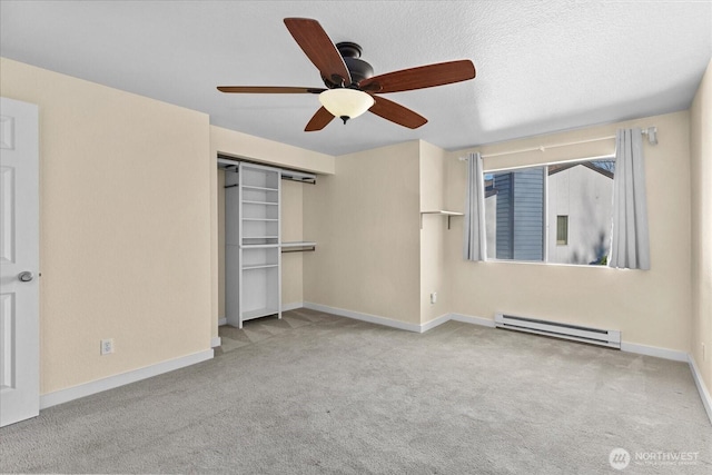 unfurnished bedroom with a textured ceiling, a baseboard heating unit, baseboards, a closet, and carpet