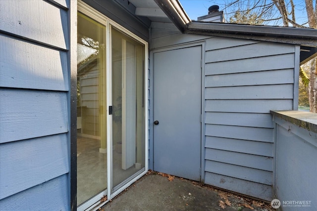 entrance to property featuring a chimney