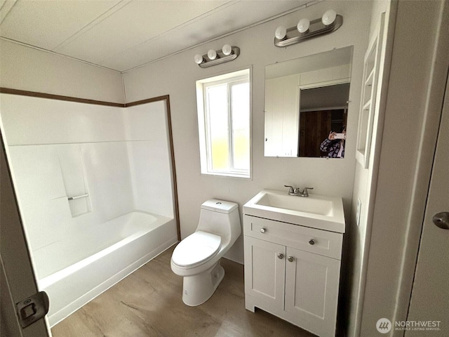 full bath featuring shower / tub combination, toilet, vanity, and wood finished floors