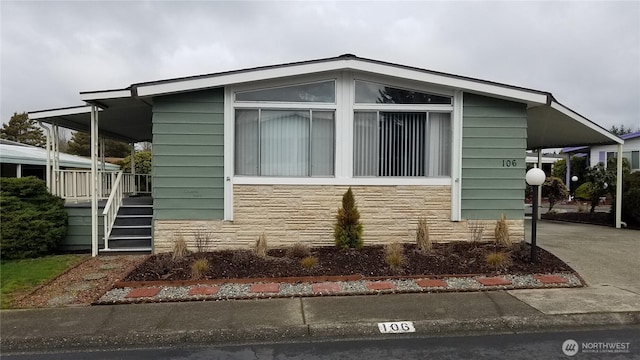 view of side of home featuring stone siding