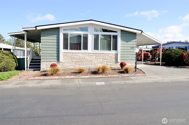 11436 SE 208th St Unit 106, Kent, WA 98031 - manufactured / mobile home featuring stone siding, driveway, an attached carport, and stairs