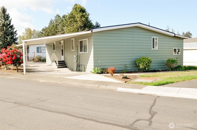 11436 SE 208th St Unit 106, Kent, WA 98031 - view of front facade with concrete driveway, an attached carport, and entry steps