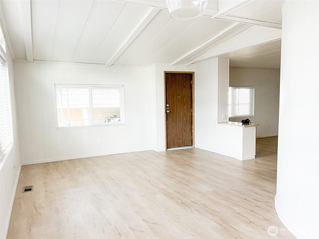 11436 SE 208th St Unit 106, Kent, WA 98031 - spare room featuring visible vents, baseboards, vaulted ceiling with beams, and wood finished floors