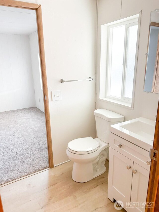 11436 SE 208th St Unit 106, Kent, WA 98031 - bathroom with toilet, vanity, and wood finished floors