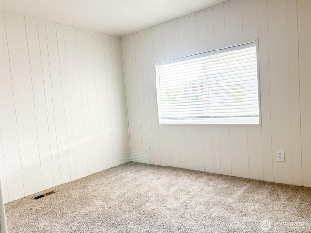 11436 SE 208th St Unit 106, Kent, WA 98031 - spare room featuring wooden walls, carpet floors, and visible vents
