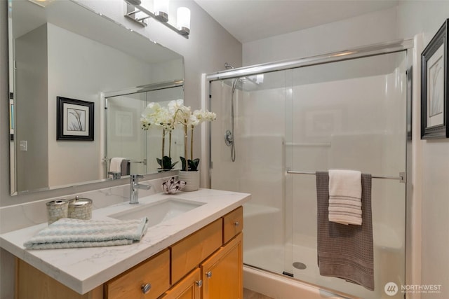 full bathroom with a stall shower and vanity