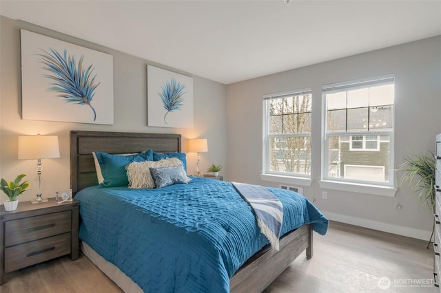 bedroom featuring wood finished floors and baseboards