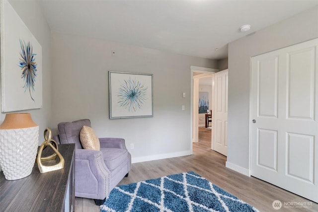 sitting room featuring baseboards and wood finished floors