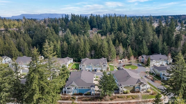 drone / aerial view with a forest view and a residential view