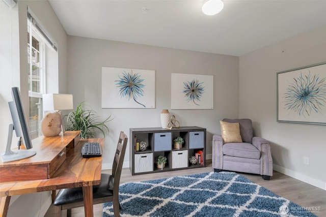 living area with wood finished floors and baseboards