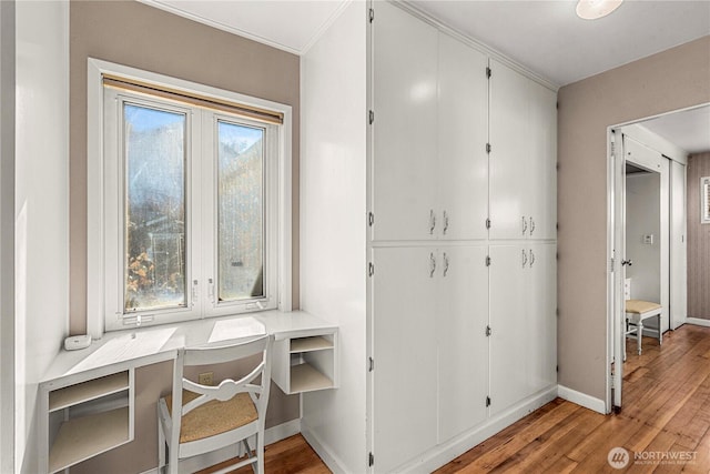 office space with light wood-style flooring and baseboards