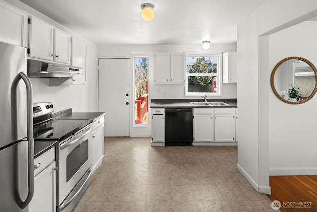 kitchen featuring white cabinets, dark countertops, appliances with stainless steel finishes, under cabinet range hood, and a sink