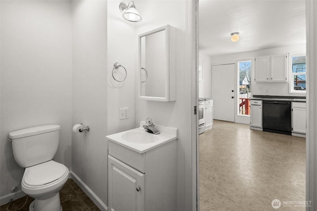 bathroom with baseboards, vanity, toilet, and tile patterned floors