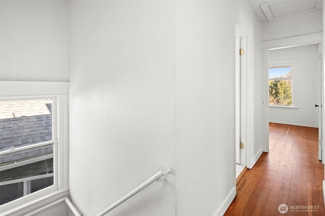 hallway with hardwood / wood-style flooring and baseboards