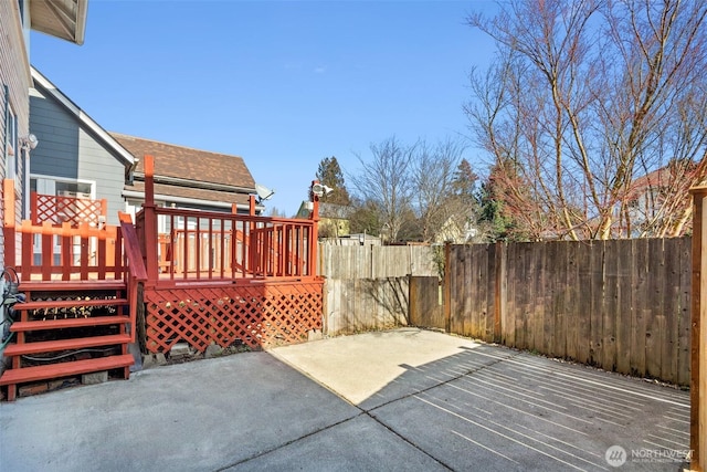 view of patio featuring a deck and fence