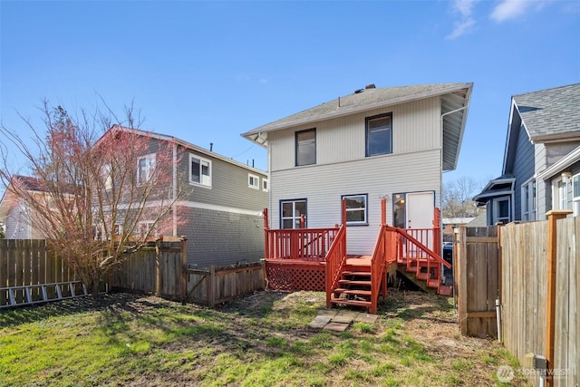 back of property featuring a deck and a fenced backyard